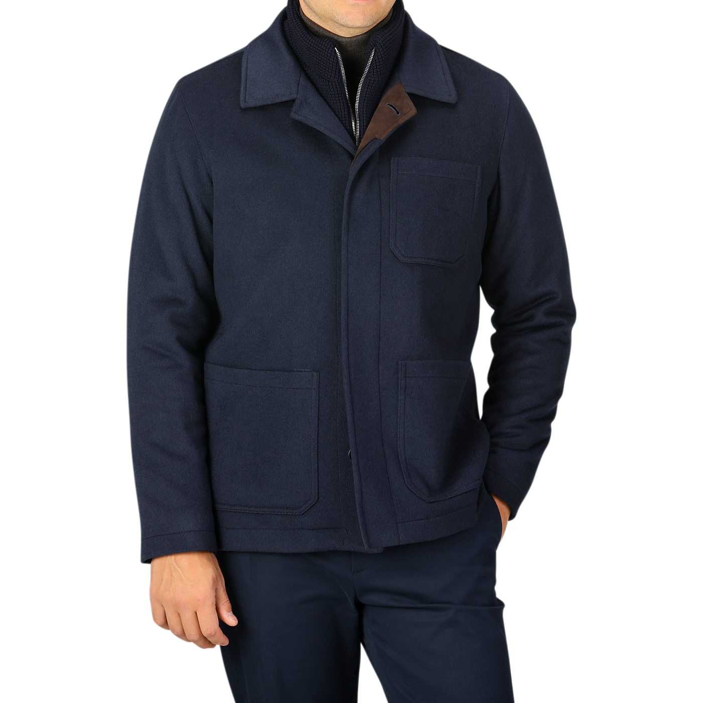 A person is wearing a Navy Cashmere Half Padded Chore Coat by Maurizio Baldassari, featuring three pockets, over a sweater with the collar partially unzipped. The background is plain and neutral.