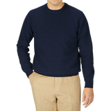 A man wearing a Maurizio Baldassari Navy Cotton Mouline Crew Neck Sweater and khaki pants.