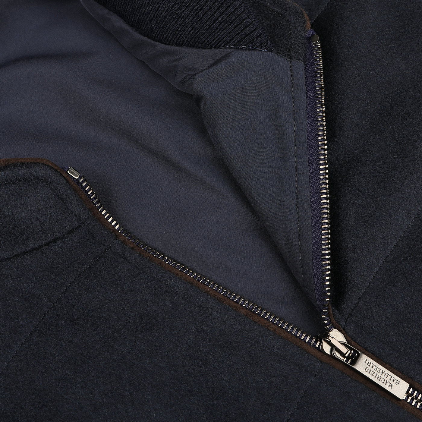 Close-up view of a partially unzipped Navy Water Repellent Pure Cashmere Gilet by Maurizio Baldassari, showcasing the inner lining and zipper details.