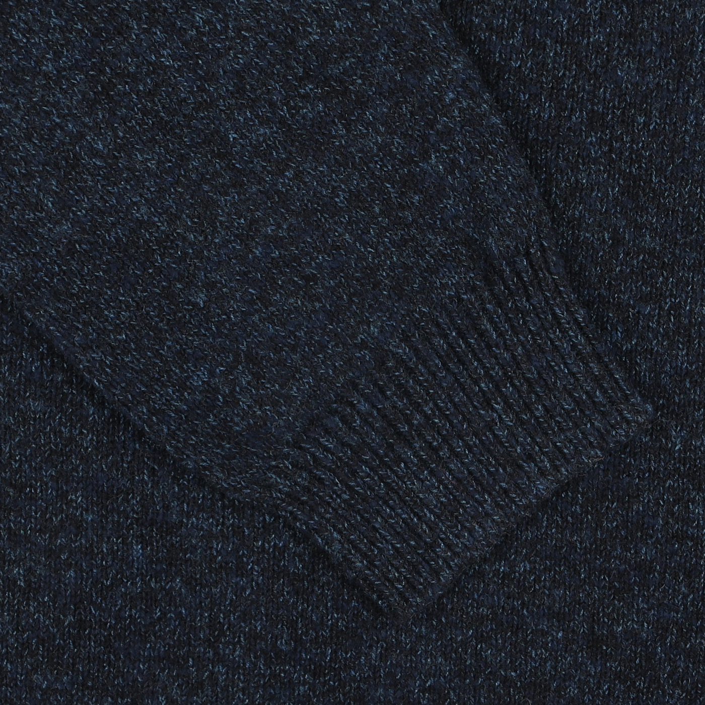 A close-up view of a ribbed-cuff sleeve from the Navy Winter Wool Mouline 1/4 Zip Sweater by Maurizio Baldassari.