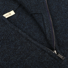 Close-up of a dark navy blue melange Navy Winter Wool Mouline 1/4 Zip Sweater with a half-zipper. A label marked "Made in Italy" is partially visible inside the collar, showcasing the brand Maurizio Baldassari.