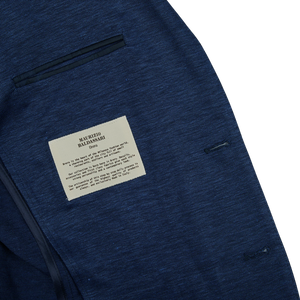 A Maurizio Baldassari dark blue wool linen silk jersey blazer with a label on it.