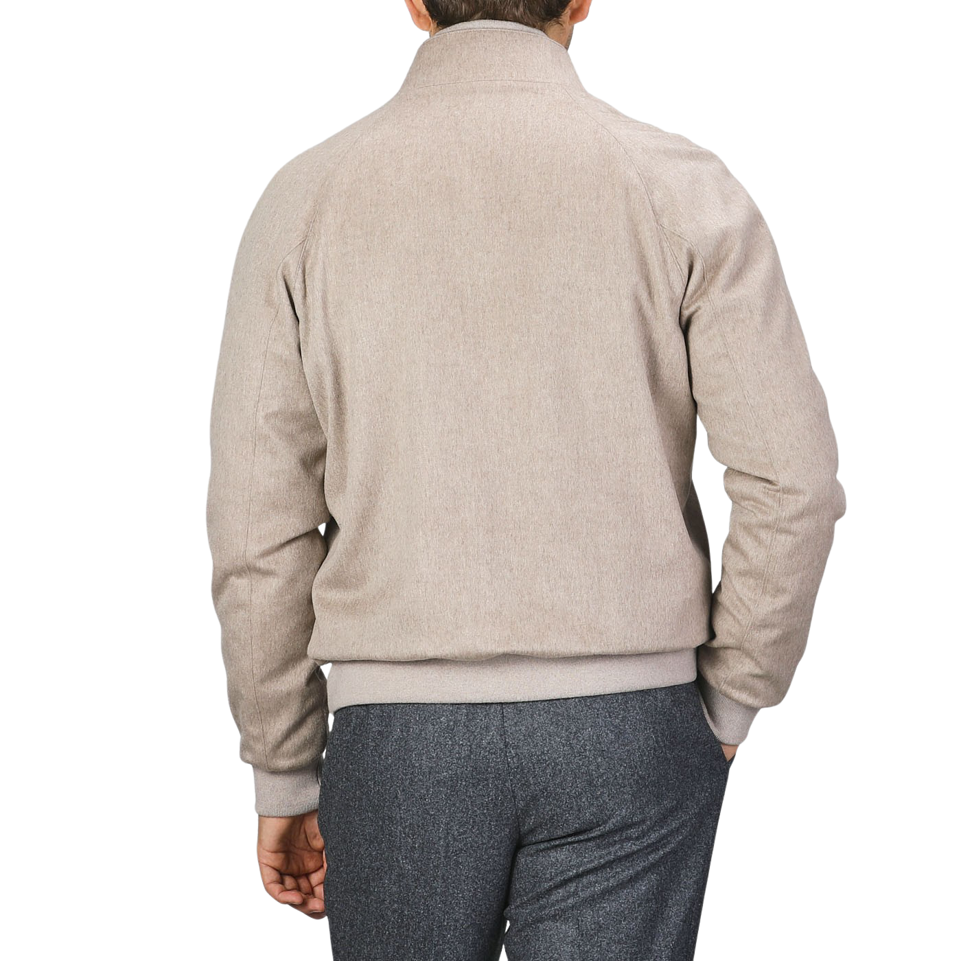 A person wearing a Maurizio Baldassari Oatmeal Beige Cashmere Zip Blouson with ribbed hems and gray trousers is seen from the back, standing against a plain background.