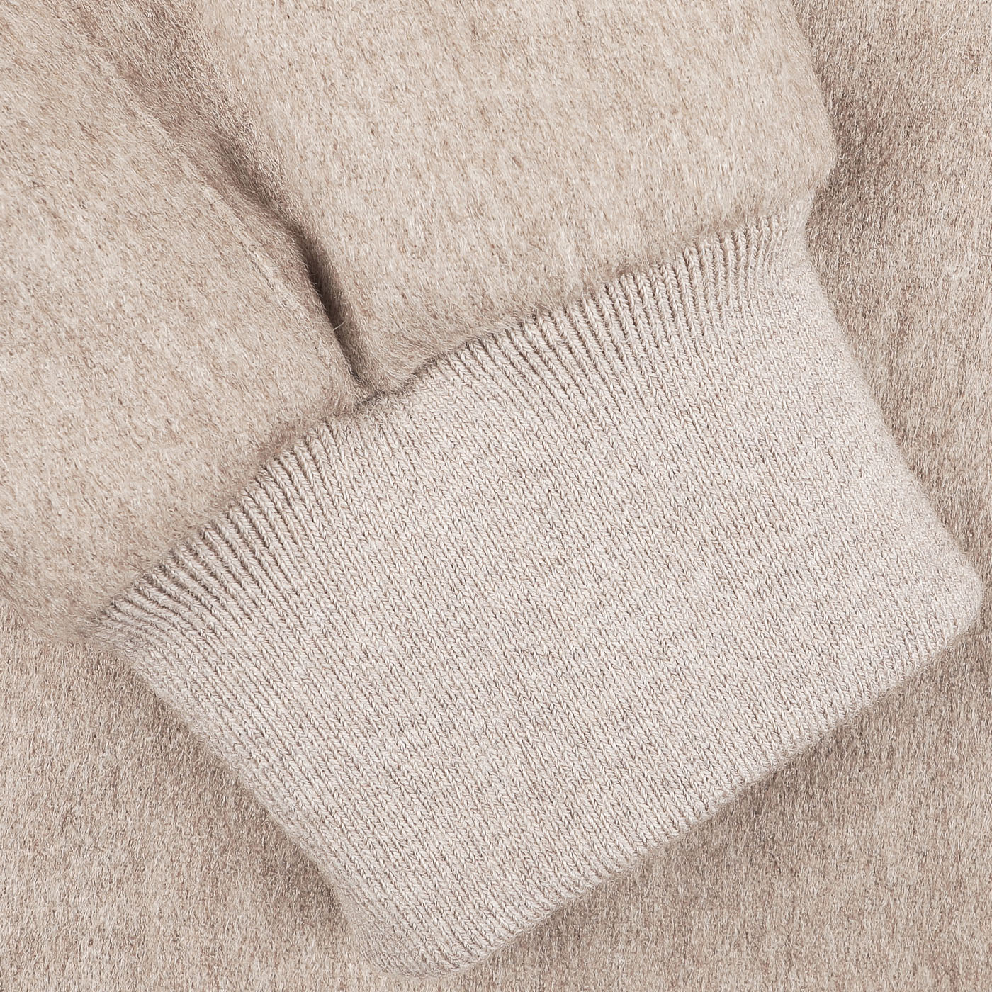 Close-up of the Oatmeal Beige Cashmere Zip Blouson's cuff by Maurizio Baldassari, highlighting its ribbed knit texture and refined ribbed hems.