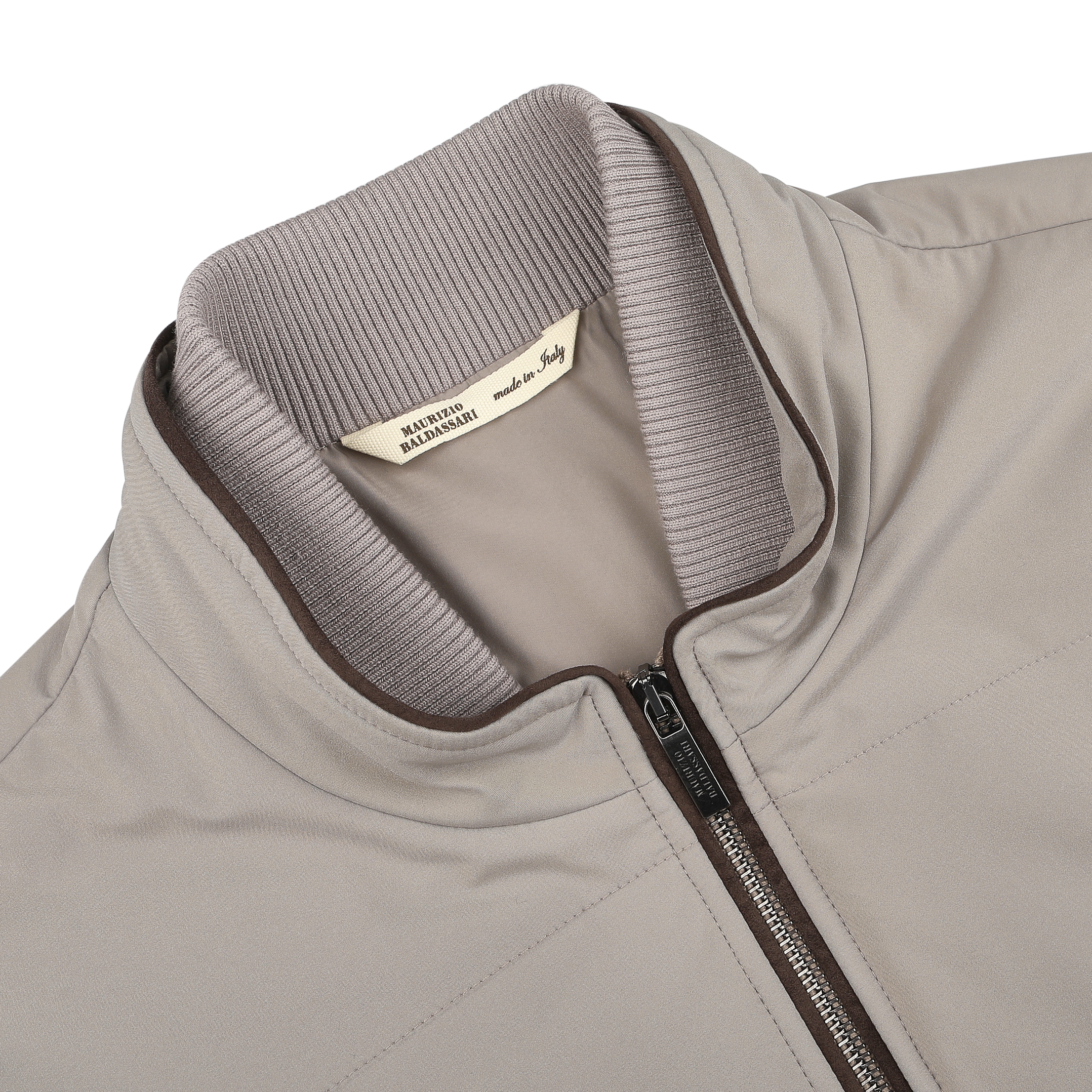 Close-up of a Pale Beige Nylon Thermore Travel Gilet by Maurizio Baldassari, featuring a ribbed collar and visible zipper. "Made in Italy" tag ensures lightweight comfort and style in this spring design.