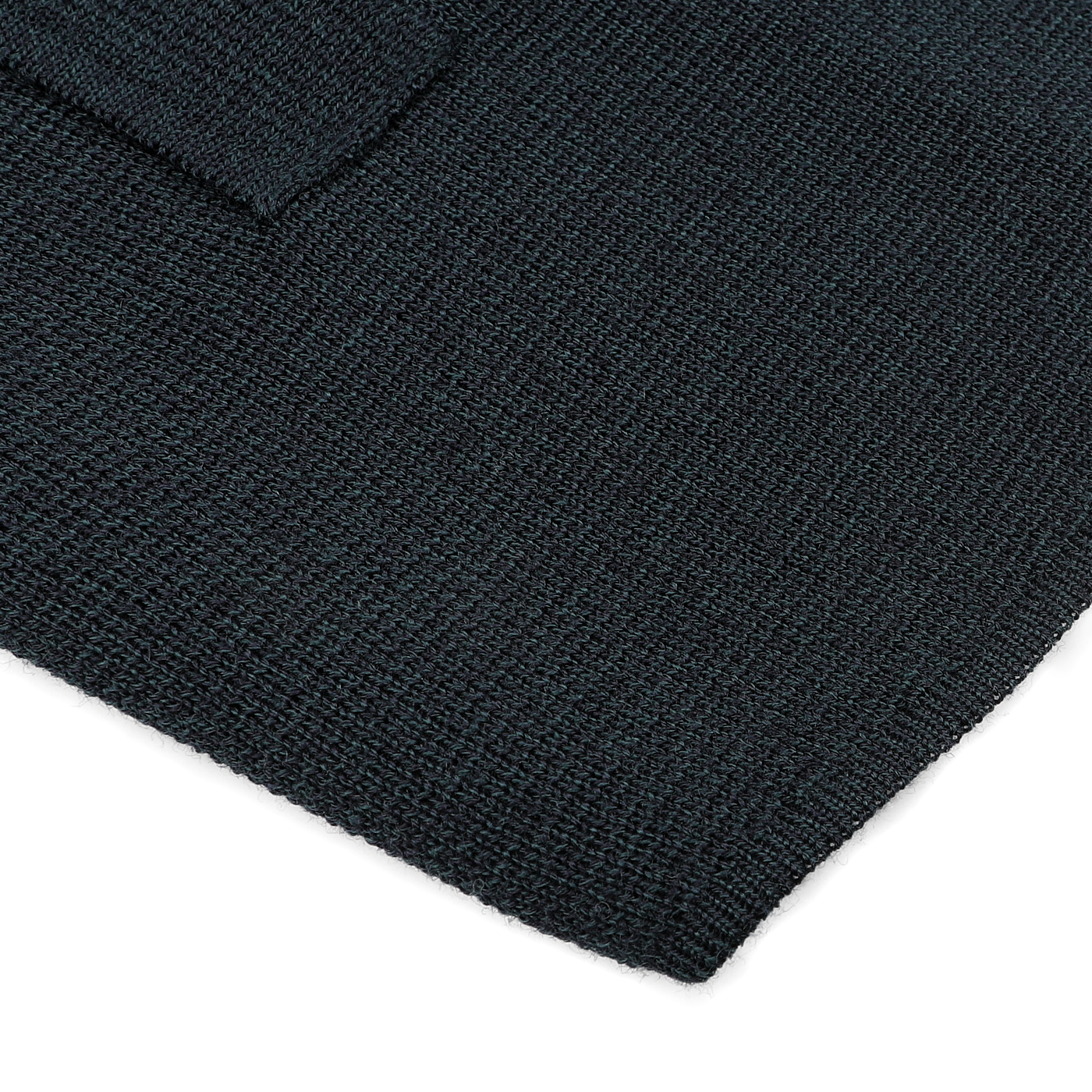 Close-up of a dark textured fabric with a small folded edge, possibly part of the Petrol Green Milano Knitted Wool Overshirt by Maurizio Baldassari.