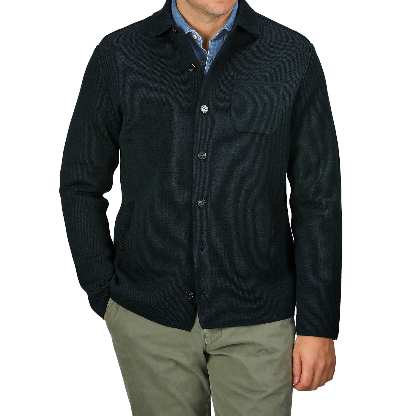 A person wearing a Petrol Green Milano Knitted Wool Overshirt by Maurizio Baldassari over a light blue shirt and khaki pants, with arms at their sides.