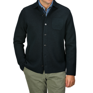 A person wearing a Petrol Green Milano Knitted Wool Overshirt by Maurizio Baldassari over a light blue shirt and khaki pants, with arms at their sides.