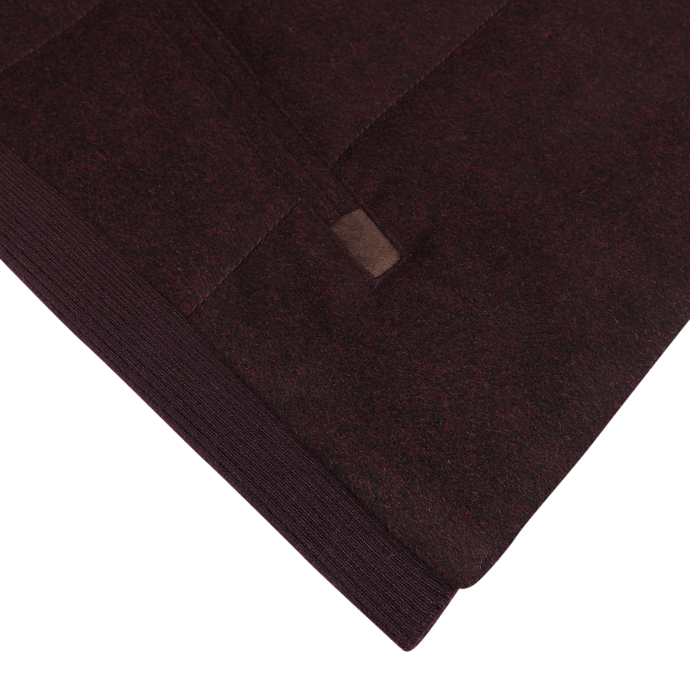 Close-up image of the Plum Water Repellent Cashmere Gilet by Maurizio Baldassari, showcasing a rich burgundy fabric with visible stitching and a small leather tag.