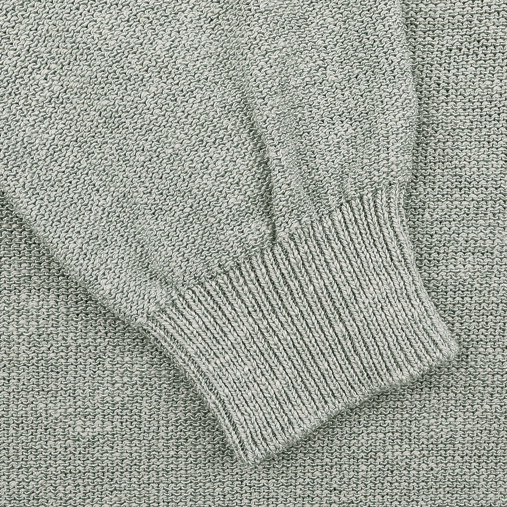 Close-up of a Maurizio Baldassari Sage Green Summer Mouline 1/4 Zip Sweater with ribbed sleeve cuff.