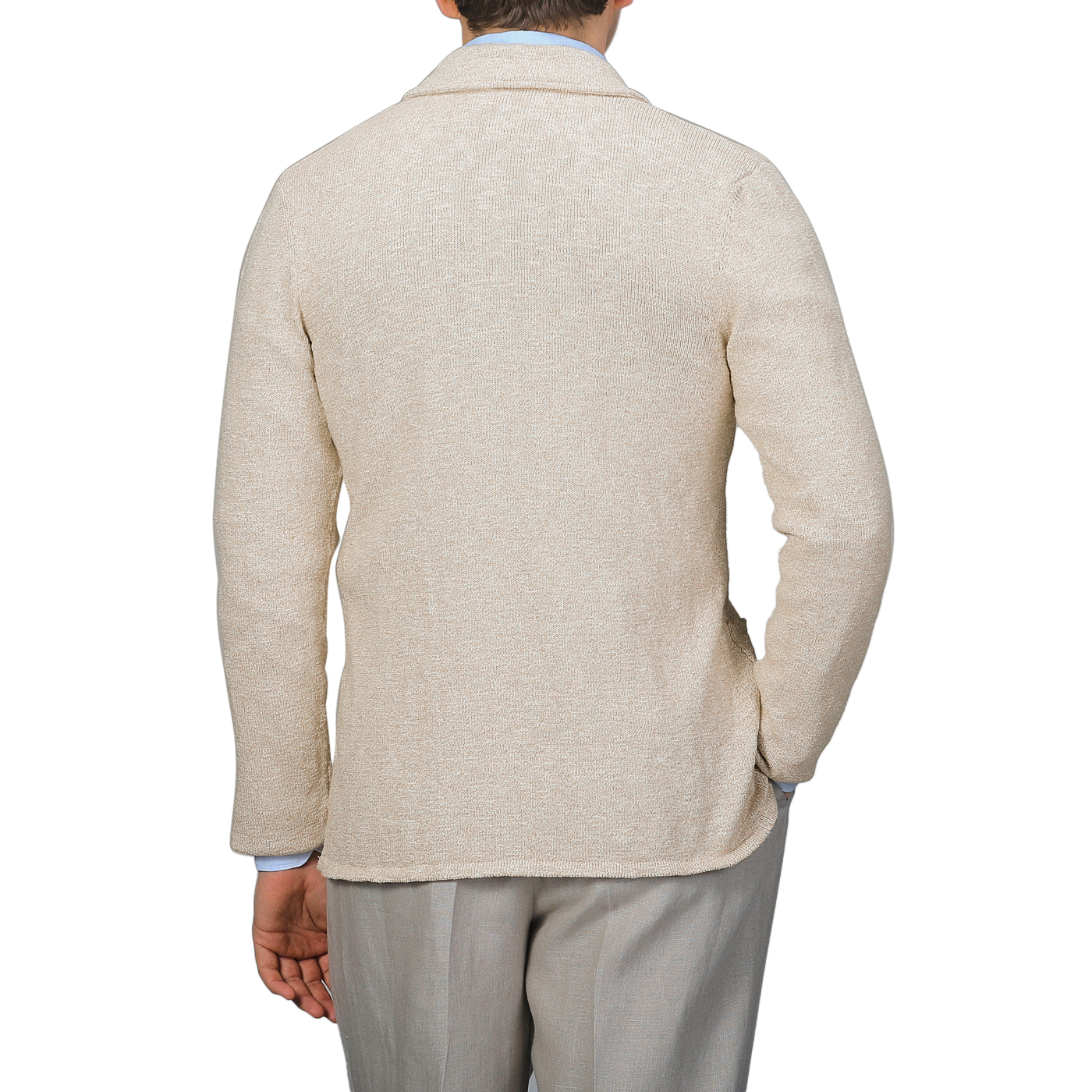 A person in a Sand Beige Summer Mouline Knitted Jacket by Maurizio Baldassari and gray pants is seen from the back against a white background, exuding relaxed luxury.