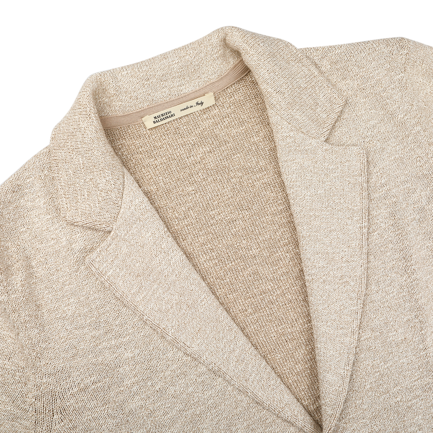 The Sand Beige Summer Mouline Knitted Jacket by Maurizio Baldassari is elegantly displayed, showcasing a cream hue with a notched lapel collar. Crafted from a cotton-viscose blend, it features a textured finish and visible interior label, embodying relaxed luxury.