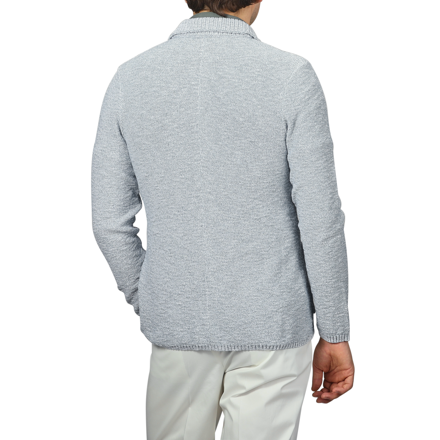 A person is shown from the back against a plain background, wearing a sky blue summer Mouline knitted jacket and white pants, highlighting the timeless elegance of Maurizio Baldassari's designs.