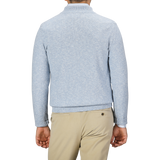 A man is seen from behind wearing a Sky Blue Winter Wool Mouline 1/4 Zip Sweater by Maurizio Baldassari and beige pants.