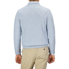 A man is seen from behind wearing a Sky Blue Winter Wool Mouline 1/4 Zip Sweater by Maurizio Baldassari and beige pants.