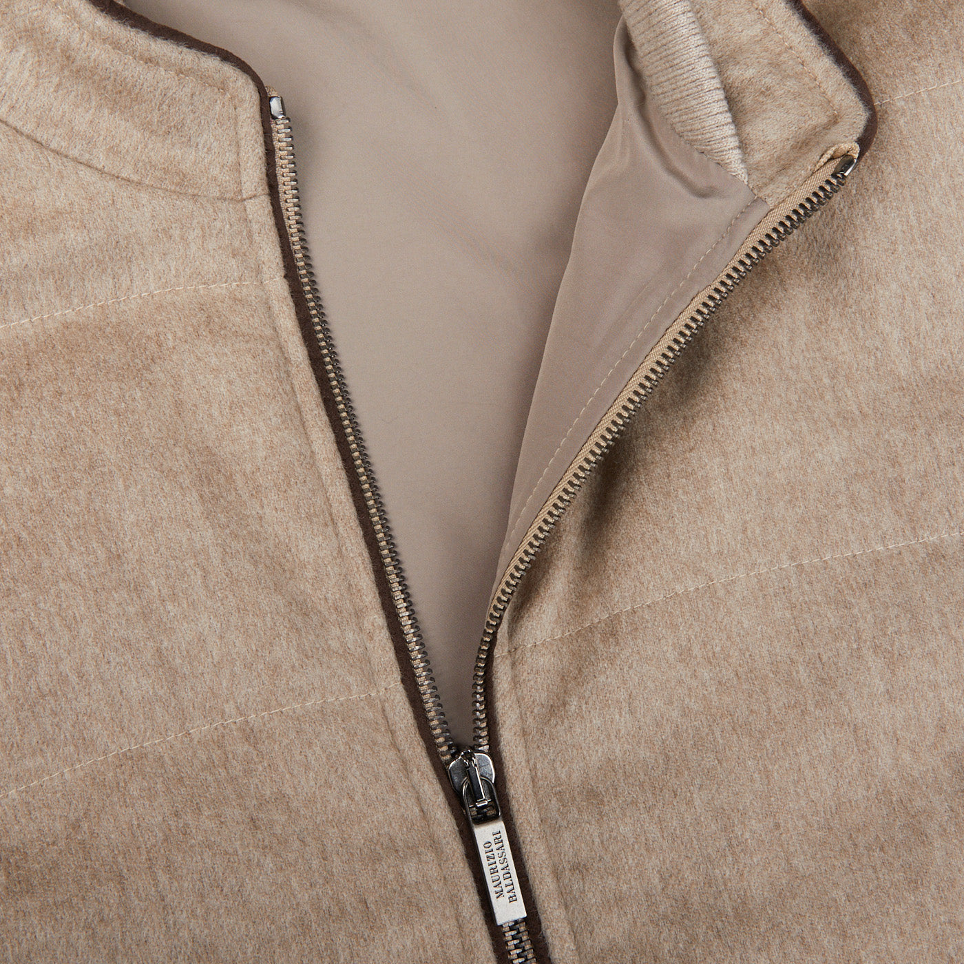 A close up of a Maurizio Baldassari Beige Water Repellent Pure Cashmere Gilet zippered jacket.