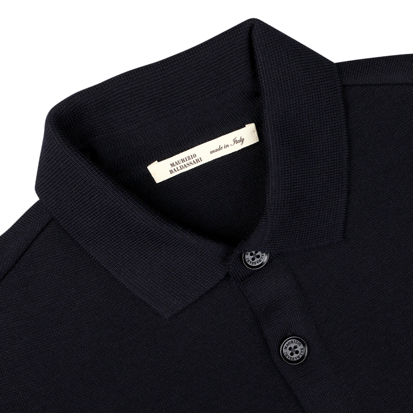 Close-up image of the Navy Blue Wool Milano Knitted Overshirt by Maurizio Baldassari, featuring buttons. A label inside the collar reads "MAURIZIO BALDASSARI made in Italy," showcasing its Milano stitch craftsmanship and pure virgin wool fabric.