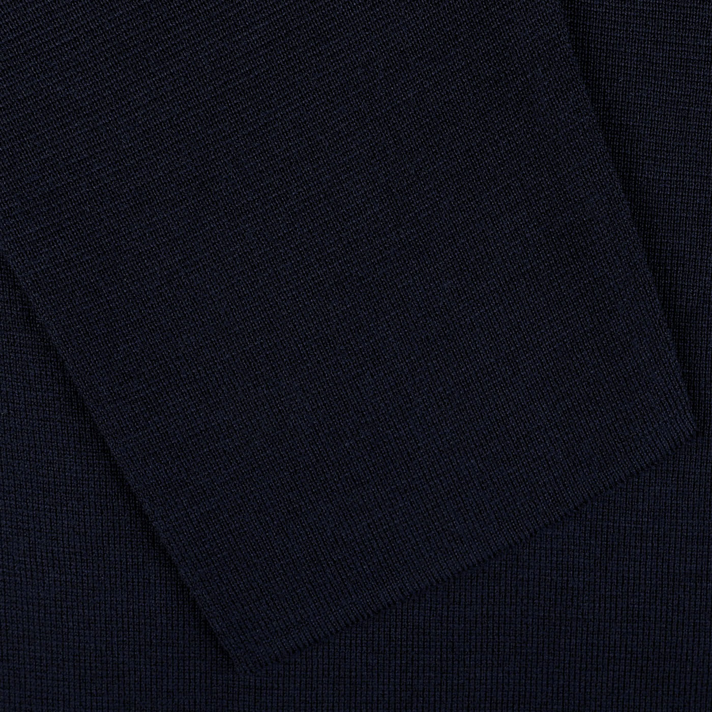 The Maurizio Baldassari Navy Blue Wool Milano Knitted Overshirt, crafted from pure virgin wool, showcases a dark blue fabric with a visible pocket or folded section.