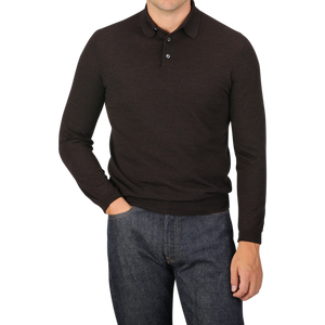 A man wearing a Mauro Ottaviani Brown Melange 16 Gauge Merino Wool Polo Shirt and blue jeans with his right hand in his pocket, standing against a plain gray background.