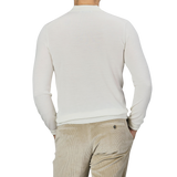 Man wearing a Mauro Ottaviani Cream 16 Gauge Merino Wool Polo Shirt and beige corduroy pants, photographed from the back.