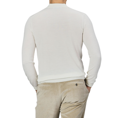 Man wearing a Mauro Ottaviani Cream 16 Gauge Merino Wool Polo Shirt and beige corduroy pants, photographed from the back.