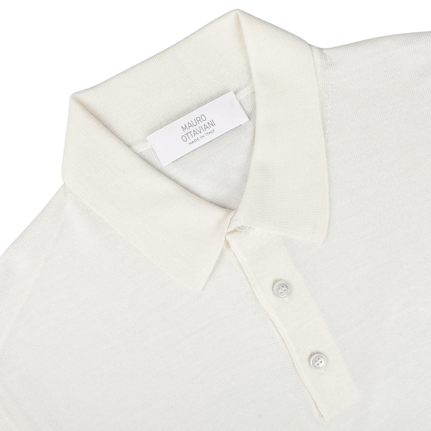 A Cream 16 Gauge Merino Wool Polo Shirt by Mauro Ottaviani is laid flat. The shirt has a plastic tag with the name "Mauro Ottaviani" and "Made in Italy" on it. The collar and three front buttons are clearly visible, showcasing its contemporary fit.