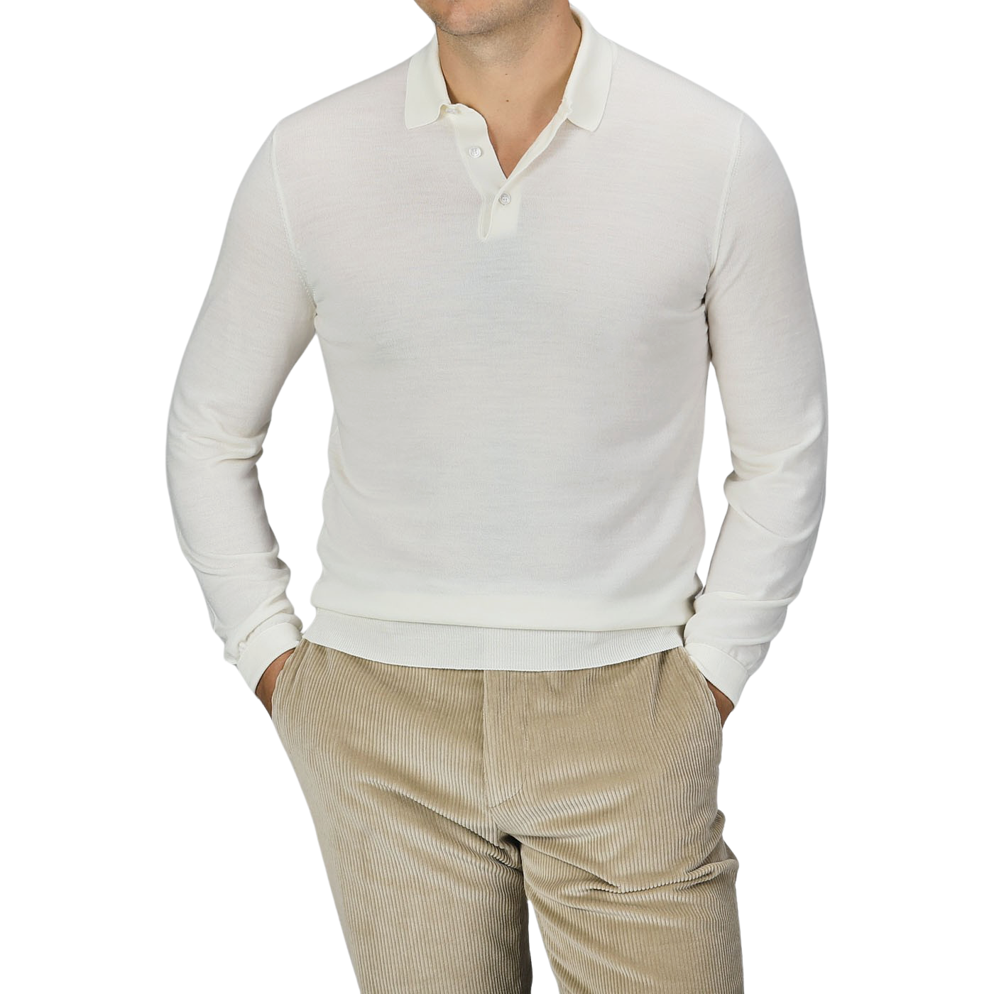 A person wearing a Mauro Ottaviani Cream 16 Gauge Merino Wool Polo Shirt and beige corduroy pants stands with their hands in their pockets against a plain background.