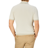 A person photographed from behind wearing a Mauro Ottaviani Cream Beige Cotton Rib-Knitted Polo Shirt and tan trousers.