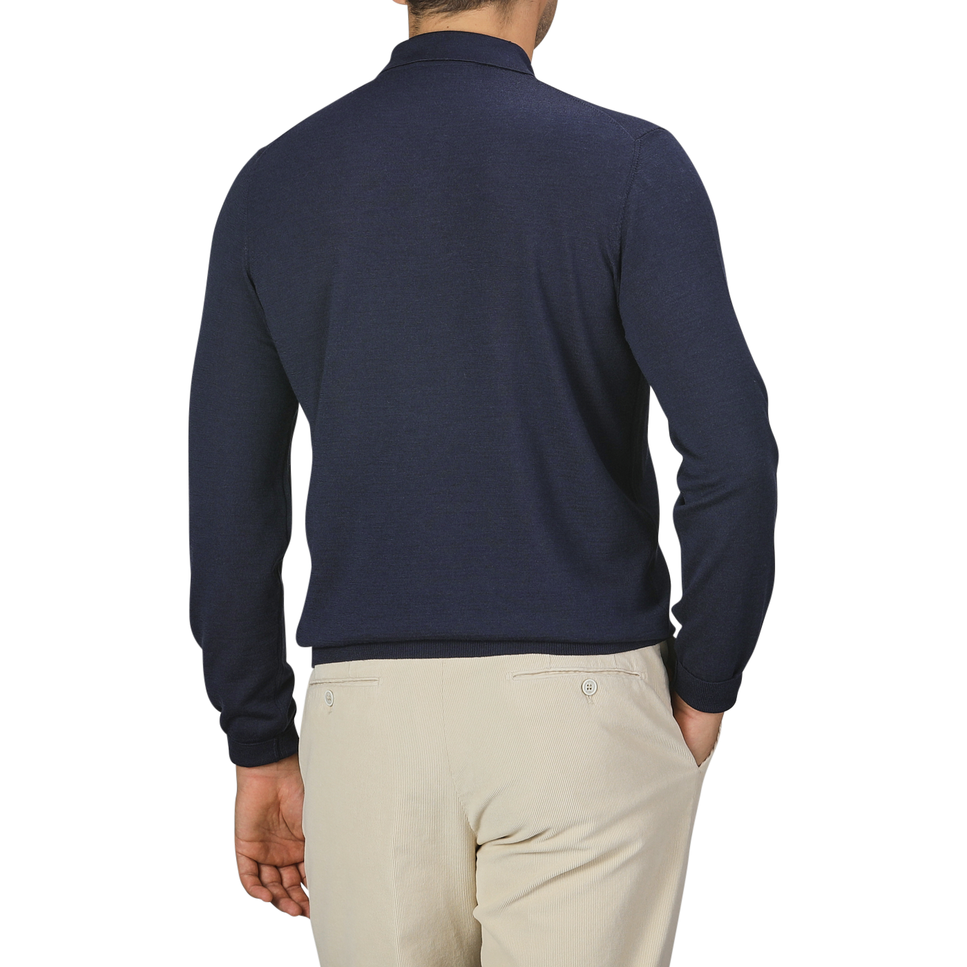 A person is standing with their back to the camera, wearing a Mauro Ottaviani Dark Blue 16 Gauge Merino Wool Polo Shirt and beige pants. The background is plain and light-colored.