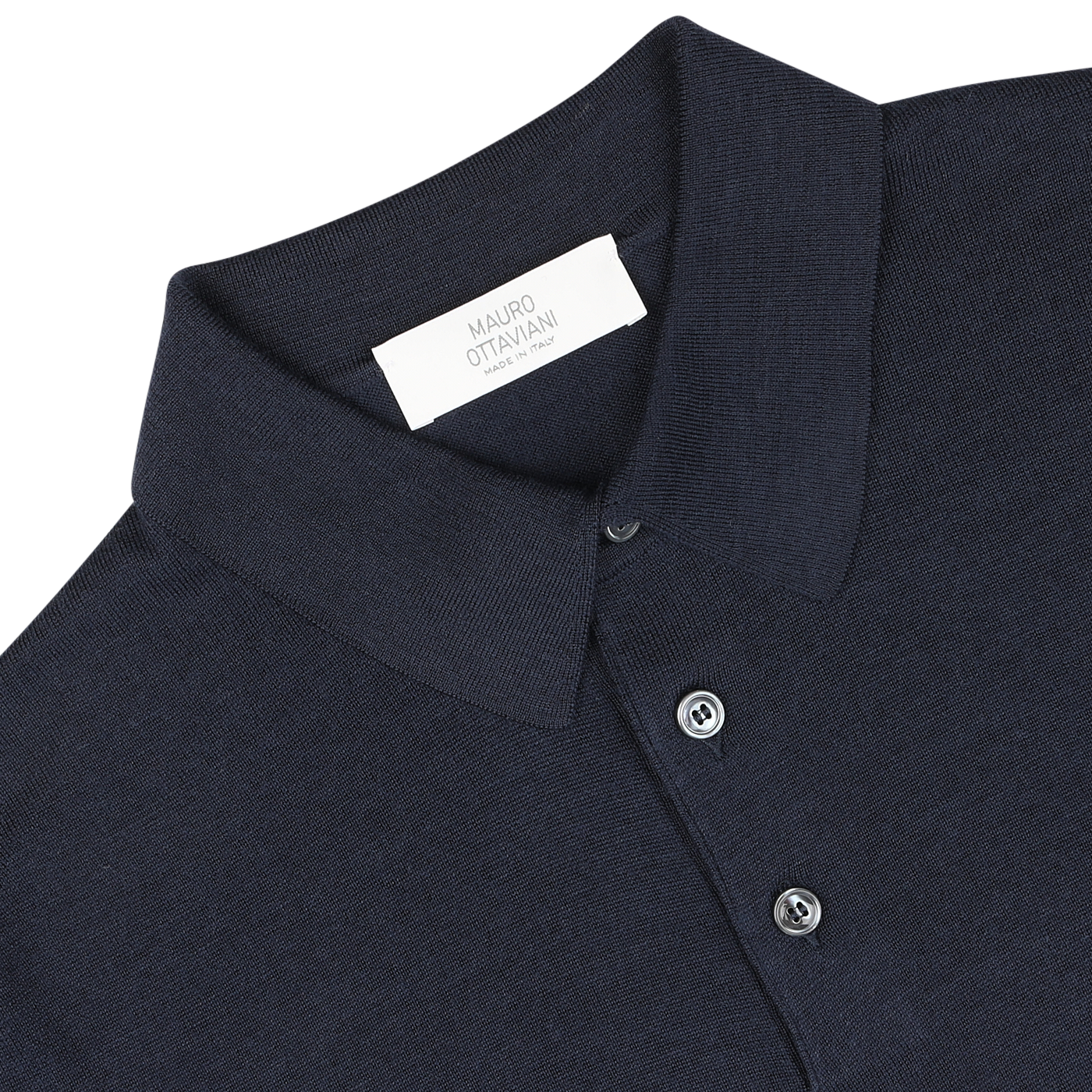 A close-up image of a Dark Blue 16 Gauge Merino Wool Polo Shirt with a white tag inside the collar that reads "Mauro Ottaviani." This shirt features long sleeves and buttons along the front, offering both style and comfort.