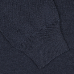 Close-up of the sleeve and cuff of a dark blue, 16 gauge Merino wool long-sleeve polo shirt by Mauro Ottaviani, showcasing the intricate texture and stitching details.