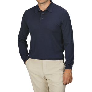 A person is wearing a Mauro Ottaviani Dark Blue 16 Gauge Merino Wool Polo Shirt and beige pants with hands in pockets. The person's face is not visible.