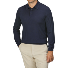 A person is wearing a Mauro Ottaviani Dark Blue 16 Gauge Merino Wool Polo Shirt and beige pants with hands in pockets. The person's face is not visible.