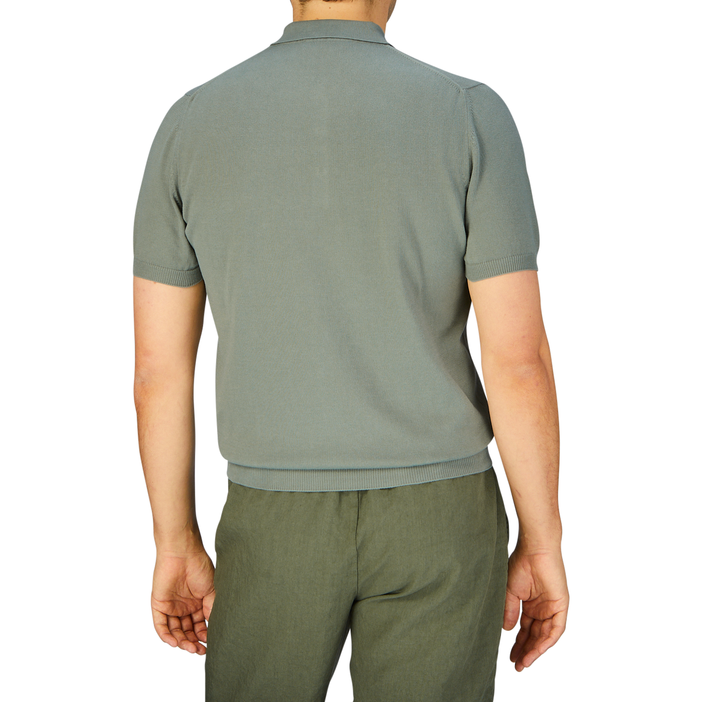 Man standing facing away from the camera, wearing a slim fit, Khaki Green Supima Cotton Polo Shirt designed by Mauro Ottaviani and matching pants.