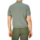 Man standing facing away from the camera, wearing a slim fit, Khaki Green Supima Cotton Polo Shirt designed by Mauro Ottaviani and matching pants.