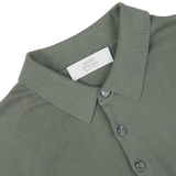 Close-up of a Mauro Ottaviani khaki green Supima cotton polo shirt collar with buttons and a designer label.