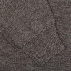 Close-up of the sleeve and cuff of the Mauro Ottaviani Light Brown 16 Gauge Merino Wool Polo Shirt. The pure merino wool fabric appears to have a soft, textured surface, offering a contemporary fit.