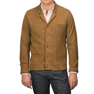 A person exudes sartorial elegance in a Tobacco Brown Linen Max 3 Chore Jacket by Max Rohr over a white shirt, perfectly paired with dark jeans.