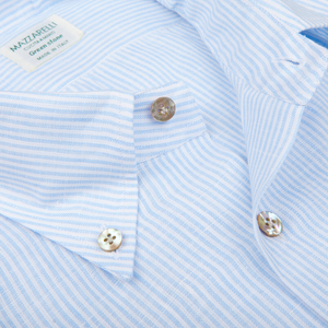 Blue and white striped Mazzarelli summer shirt with a collar detail and buttons.