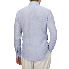 A man in a Mazzarelli Blue Striped Organic Linen BD Shirt and beige pants is seen from the back.