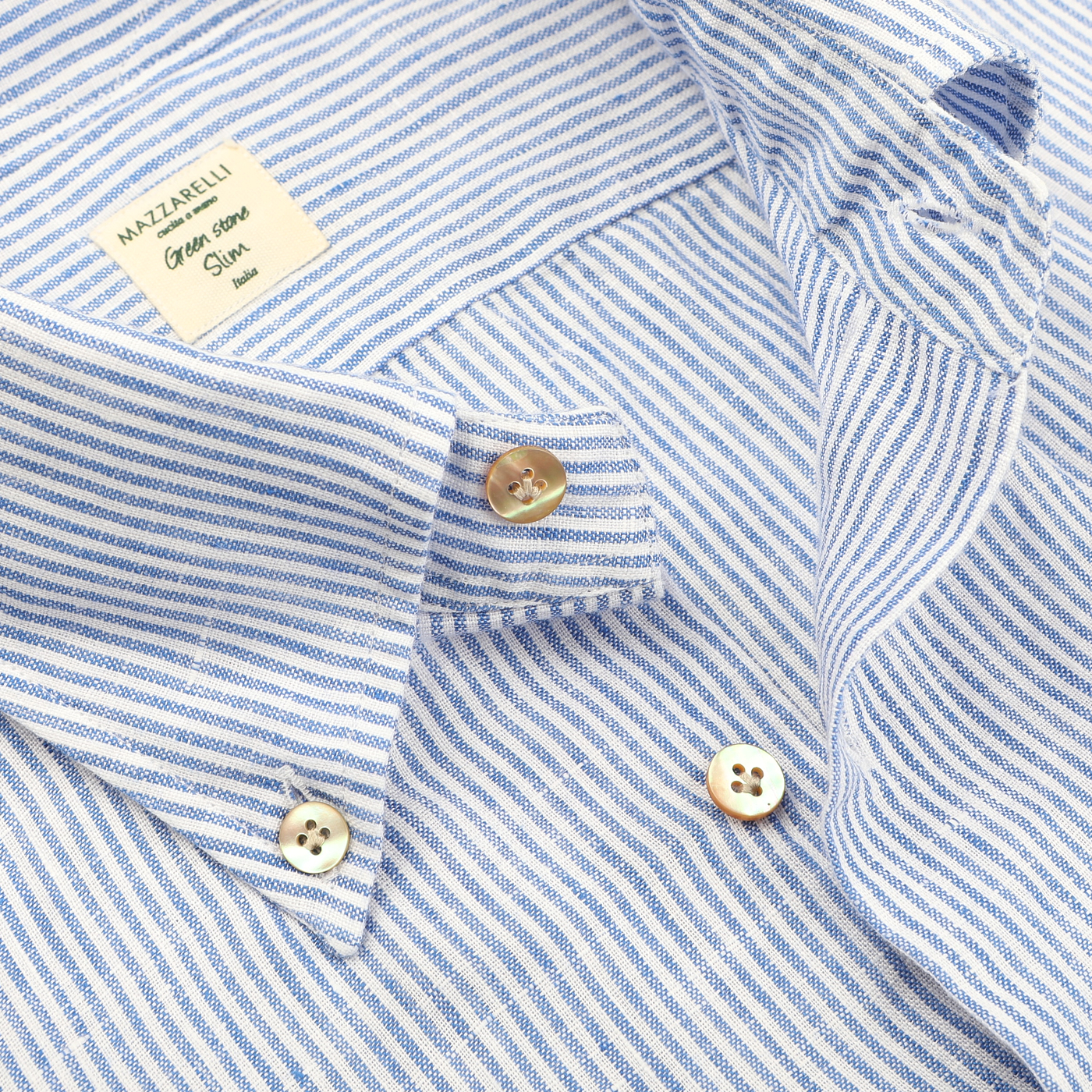 Close-up of the Blue Striped Organic Linen BD Shirt from Mazzarelli, showcasing visible buttons and a collar in light blue and white stripes.