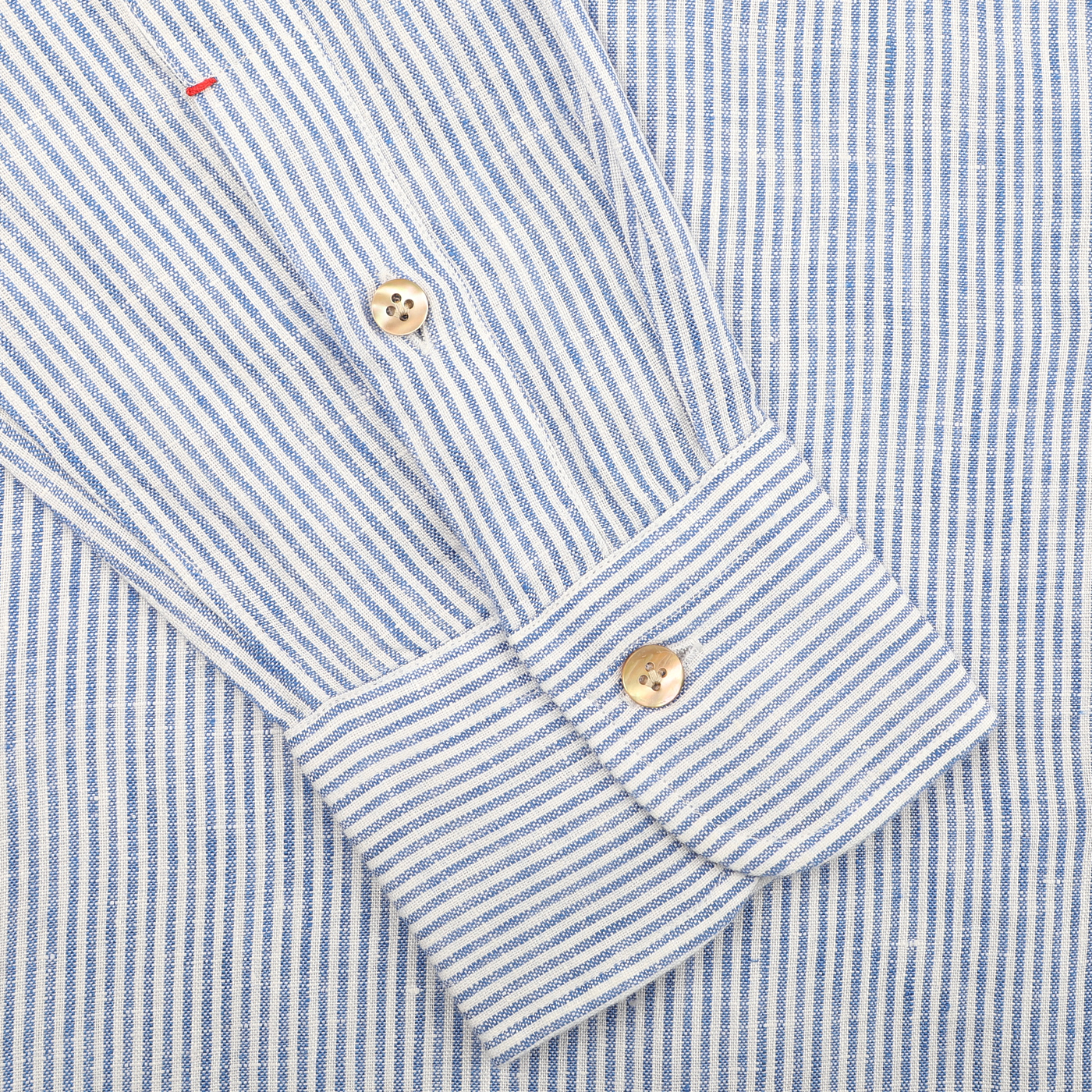 Close-up of a Blue Striped Organic Linen BD Shirt sleeve by Mazzarelli, featuring wooden buttons on the cuff, captured on a plain background.