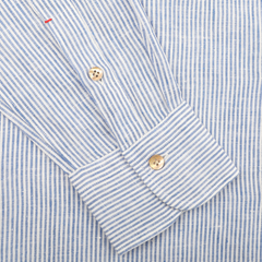 Close-up of a Blue Striped Organic Linen BD Shirt sleeve by Mazzarelli, featuring wooden buttons on the cuff, captured on a plain background.