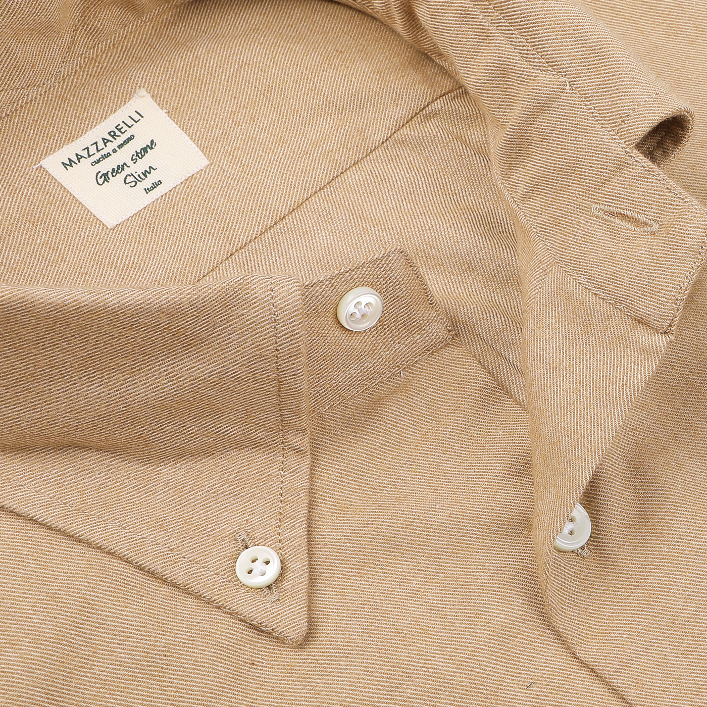 A close-up of the Camel Beige Brushed Cotton Twill BD Slim Shirt, featuring its soft button-down collar and prominent buttons. The label reads "Mazzarelli," emphasizing its fine craftsmanship in organic cotton twill.