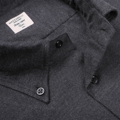 Close-up of a charcoal grey Mazzarelli dress shirt, known as the Charcoal Grey Brushed Cotton Twill BD Slim Shirt, crafted from brushed cotton twill and displaying the brand and size detail. This shirt features a pointed collar and sleek black buttons.