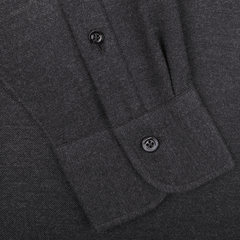 Close-up of a Mazzarelli Charcoal Grey Brushed Cotton Twill BD Slim Shirt, featuring a buttoned pocket and part of the placket with two buttons, crafted from organic cotton flannel.