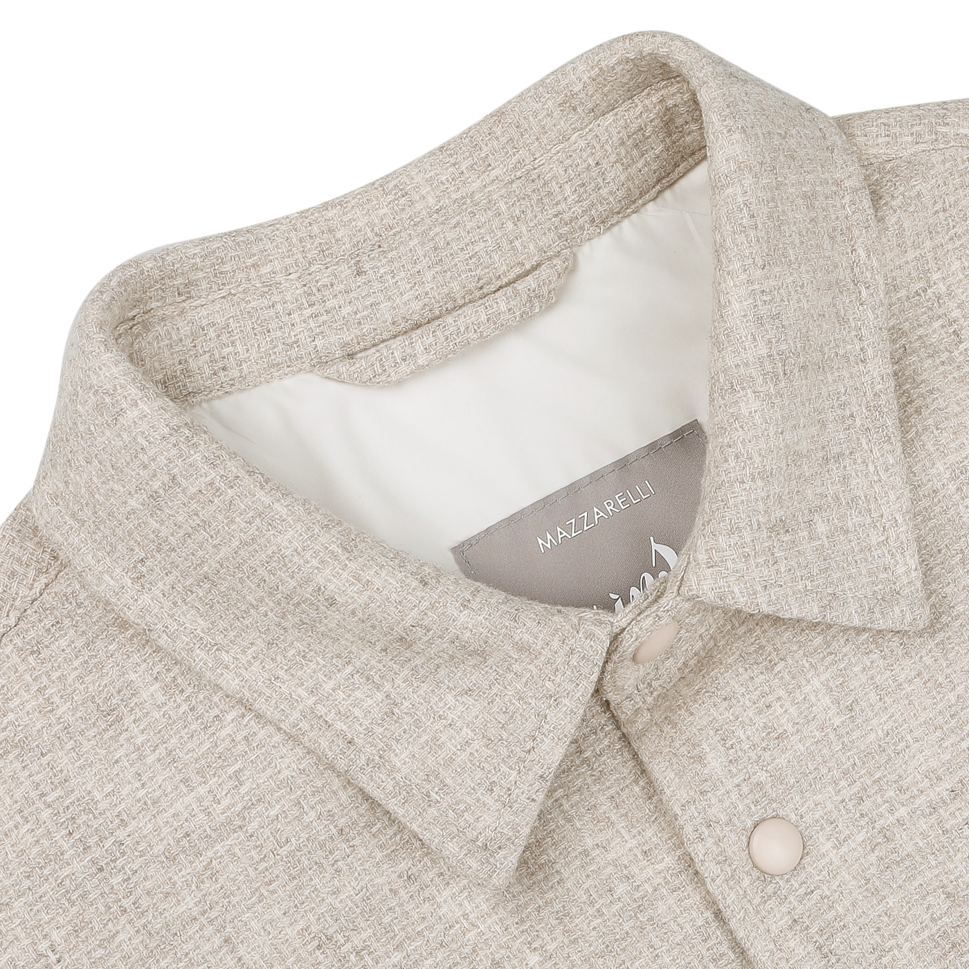 A close-up of a cream beige wool cashmere padded overshirt featuring a collar and button-down design on a white background, ideal for layering. The label reads "Mazzarelli.