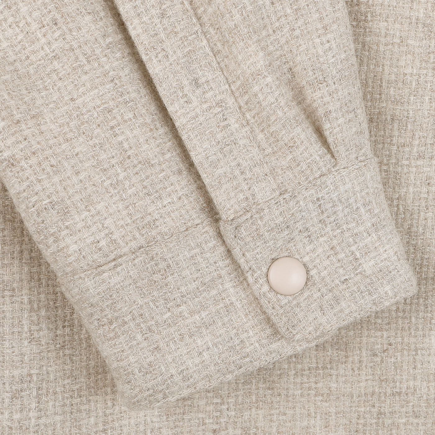 Close-up of the Cream Beige Wool Cashmere Padded Overshirt by Mazzarelli, showcasing a textured pattern and buttoned cuffs, ideal for layering.