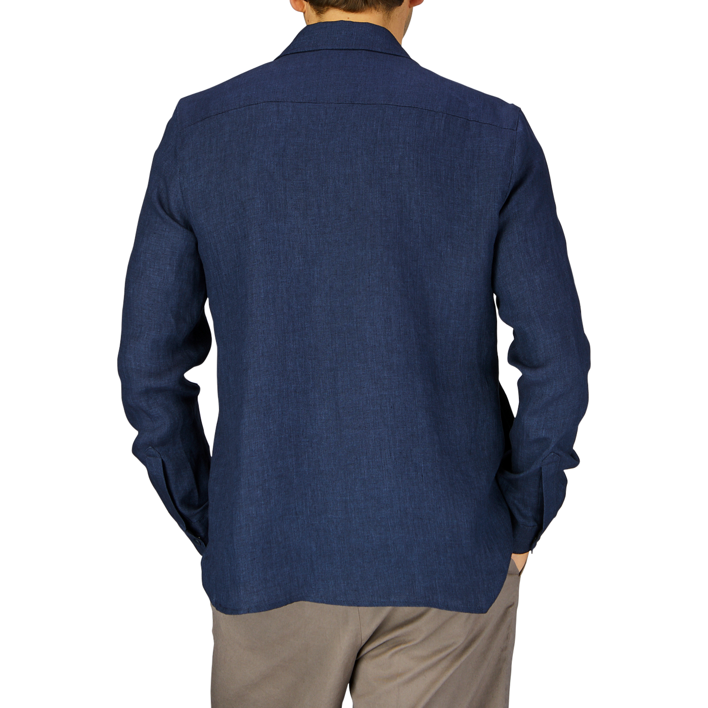 A man viewed from behind wearing a Mazzarelli Dark Blue Organic Linen Overshirt and khaki trousers against a grey background.