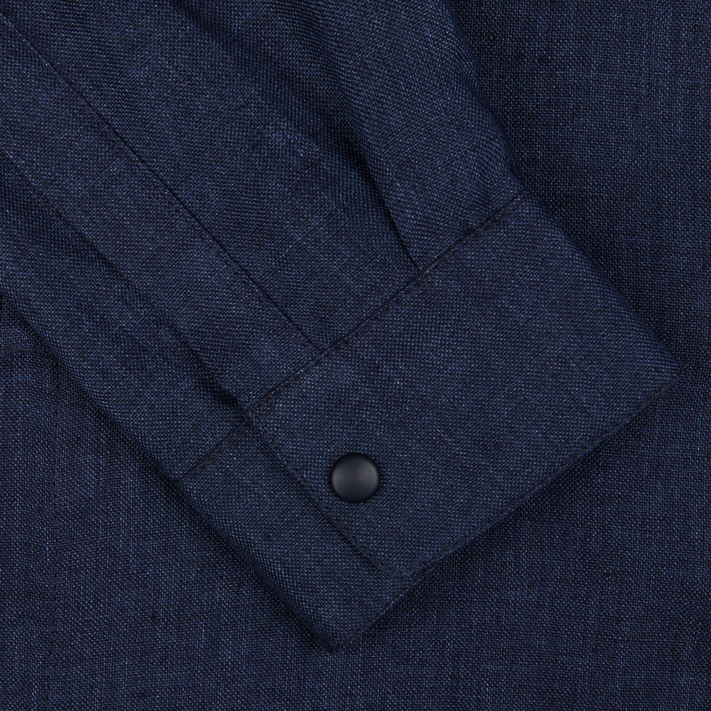 Close-up of a Mazzarelli dark blue organic linen overshirt cuff with a button.